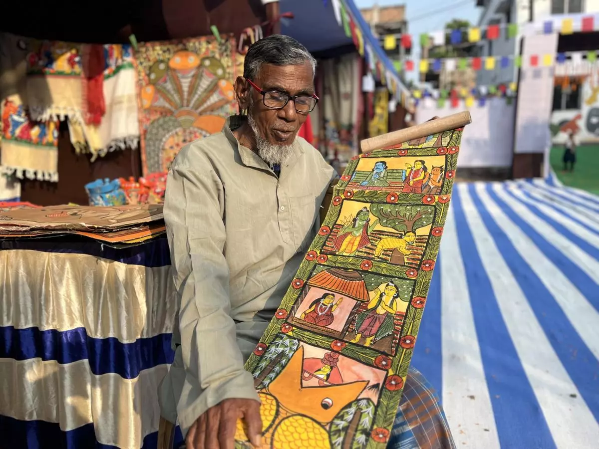 Ajoy Chitrakar with one of his creations. He remembers the hard times when, as a child, he travelled with his father from village to village with patachitra and songs in order to survive. Now the situation has changed. 