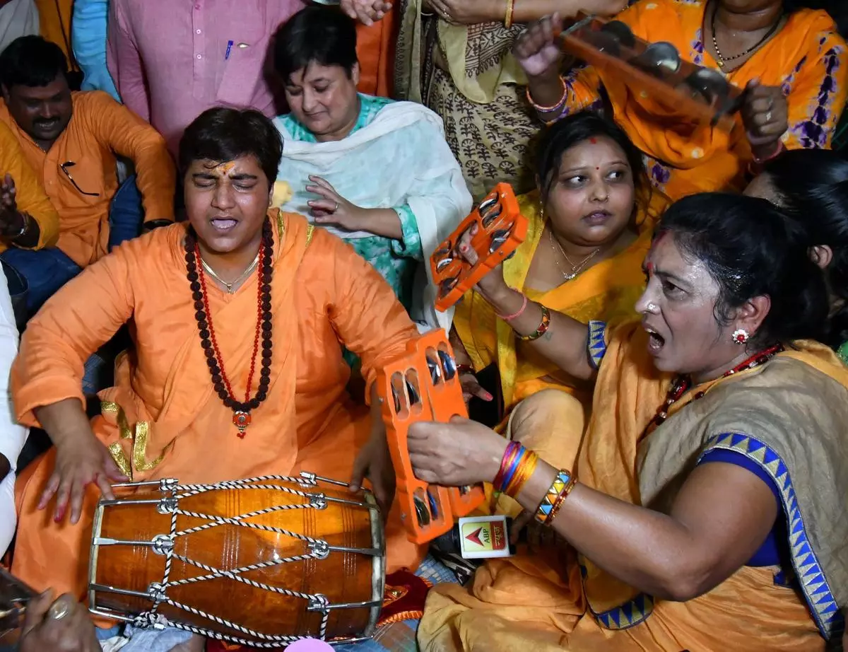 Pragya Singh Thakur (left) sings bhajans at a temple in Bhopal, Madhya Pradesh, on the second day of the 72-hour ban on her campaigning by the Election Commission in May 2019. She was banned for her speech on the Babri Masjid demolition.