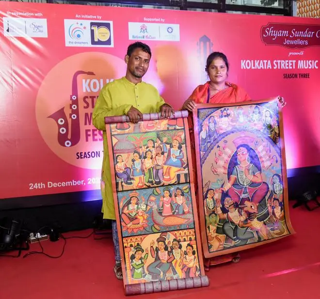 Two patachitra artistes, Kalapana Chitrakar and Nooruddin Chitrakar, narrate stories accompanying their patas at Kolkata Street Music Festival 2022. Two patachitra artistes, Kalapana Chitrakar and Nooruddin Chitrakar, narrate stories accompanying their patas at Kolkata Street Music Festival 2022.