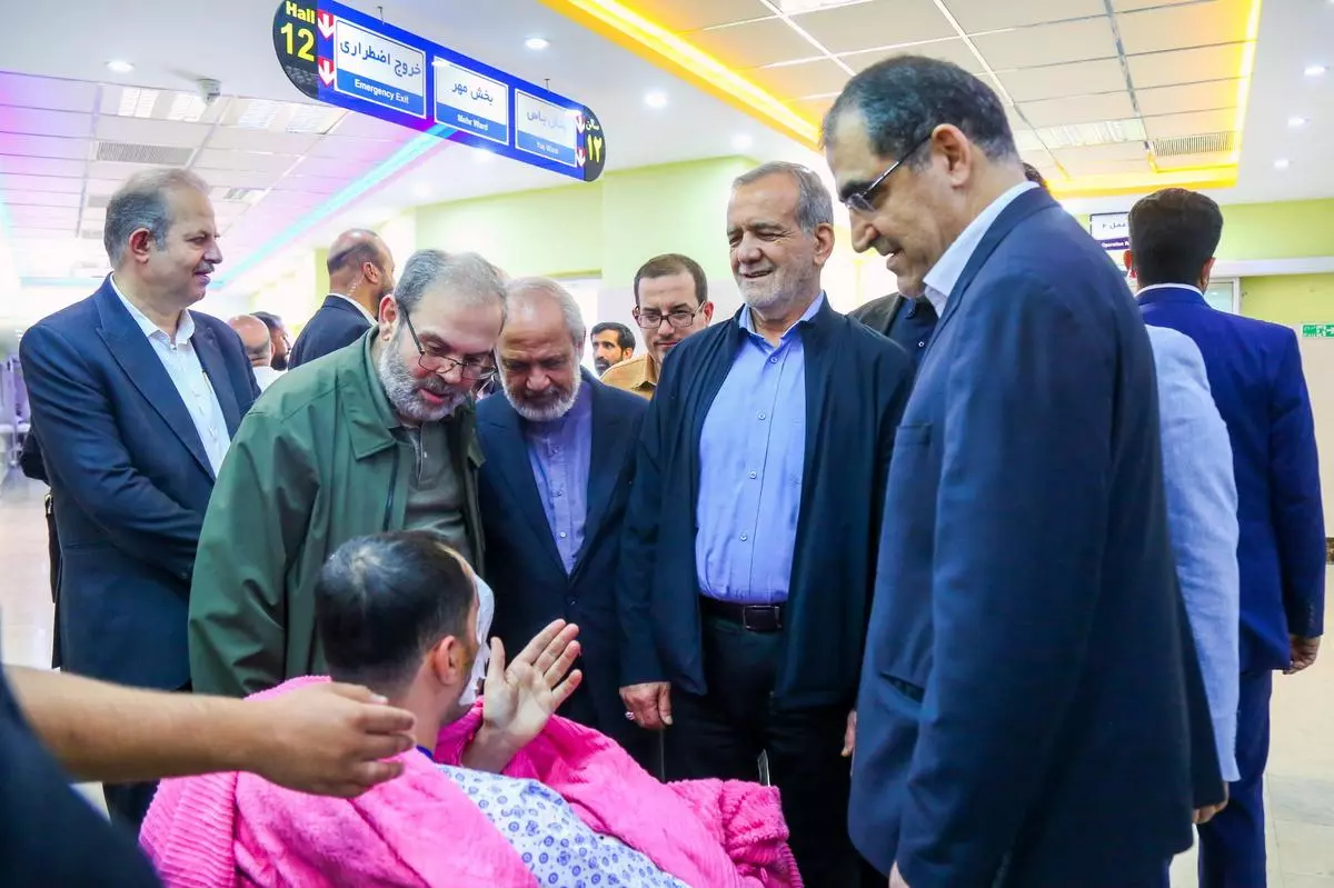 Iran’s President Masoud Pezeshkian visits one of the victims injured by pager explosions across Lebanon, in a hospital in Tehran on September 20. 