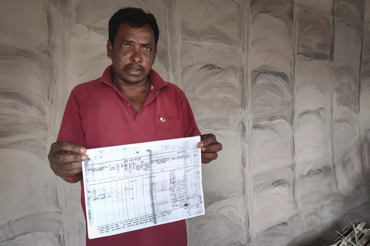 Lakhiram Mardi, an Adivasi man in Assam’s Mikir Bamuni village who lost his land, displaying the “Khatian documents”. Despite holding Rayati Khatians (official records of occupancy rights) for decades, the farmers’ claims were disregarded, and the land was sold without their consent.