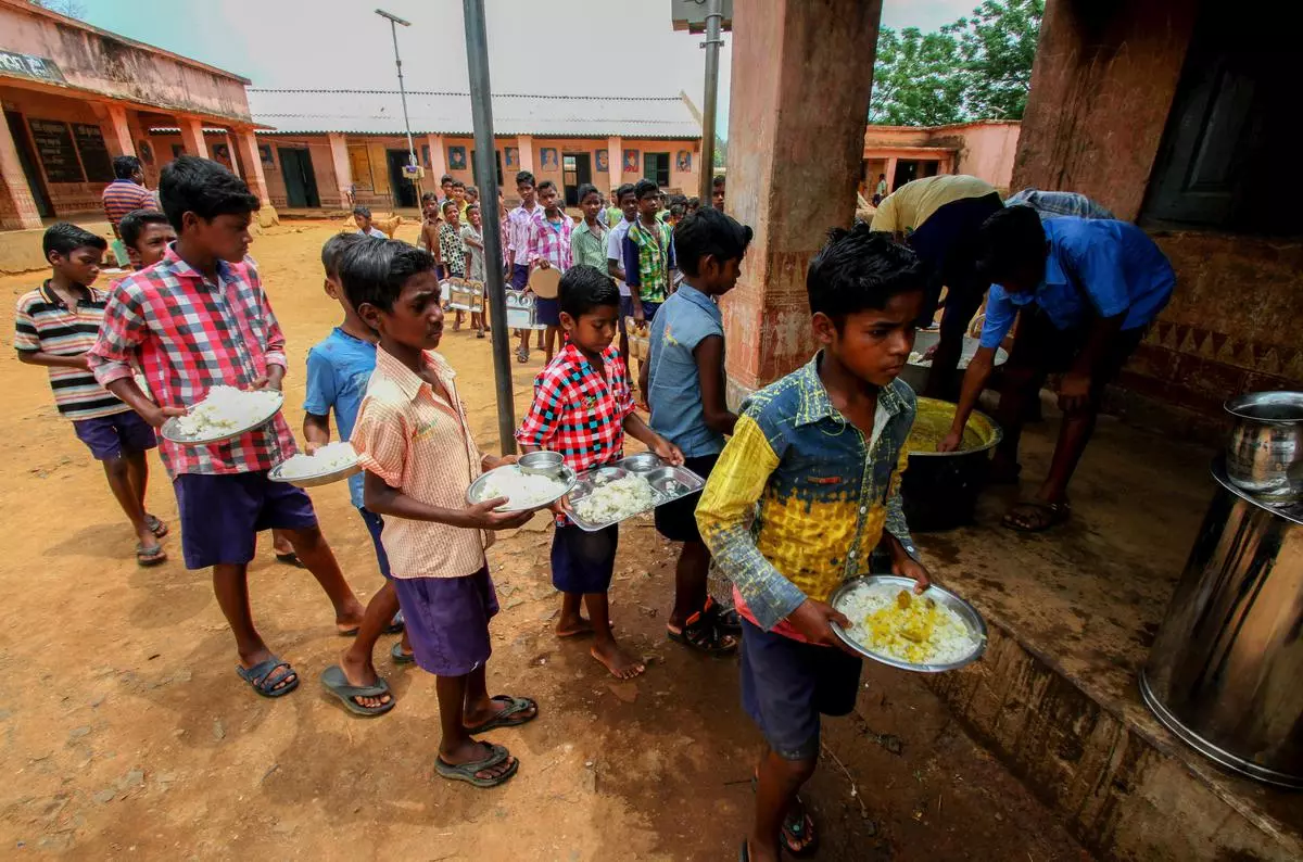 Primary school students collect midday meals inside the Similipal Tiger Biosphere Reserve in Odisha; a 2018 photograph. 
NFHS-5 shows stunting, undernourishment and anaemia conti­nue to affect a large percentage of Indian children.