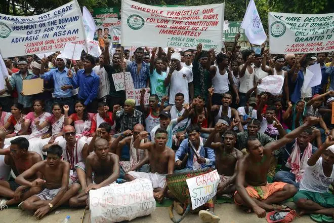 All Adivasi Students Association of Assam activists protest at Jantar Mantar in New Delhi on August 26, 2013, demanding the inclusion of the adivasis of the state in the Scheduled Tribe list. All Adivasi Students Association of Assam activists protest at Jantar Mantar in New Delhi on August 26, 2013, demanding the inclusion of the adivasis of the state in the Scheduled Tribe list.