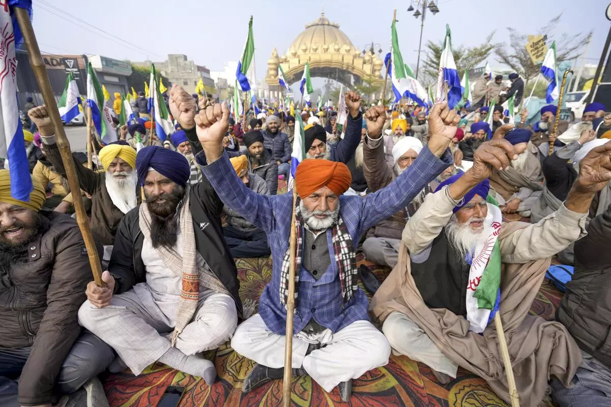 Farmers raise slogans as they block a road during the statewide “bandh” called as part of their ongoing protest, near Golden Gate in Amritsar on December 30, 2024.