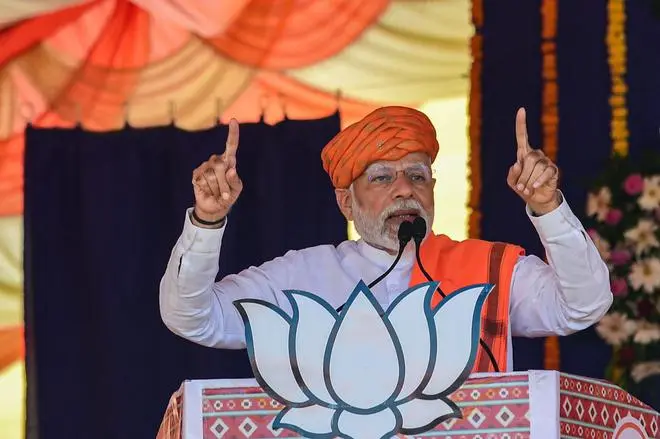 Prime Minister Narendra Modi addresses a gathering during a BJP rally ahead of the Gujarat Assembly election at Dehgam, on November 24. Modi has been reportedly making more trips to his home State than ever before as part of the electoral campaign. Prime Minister Narendra Modi addresses a gathering during a BJP rally ahead of the Gujarat Assembly election at Dehgam, on November 24. Modi has been reportedly making more trips to his home State than ever before as part of the electoral campaign.