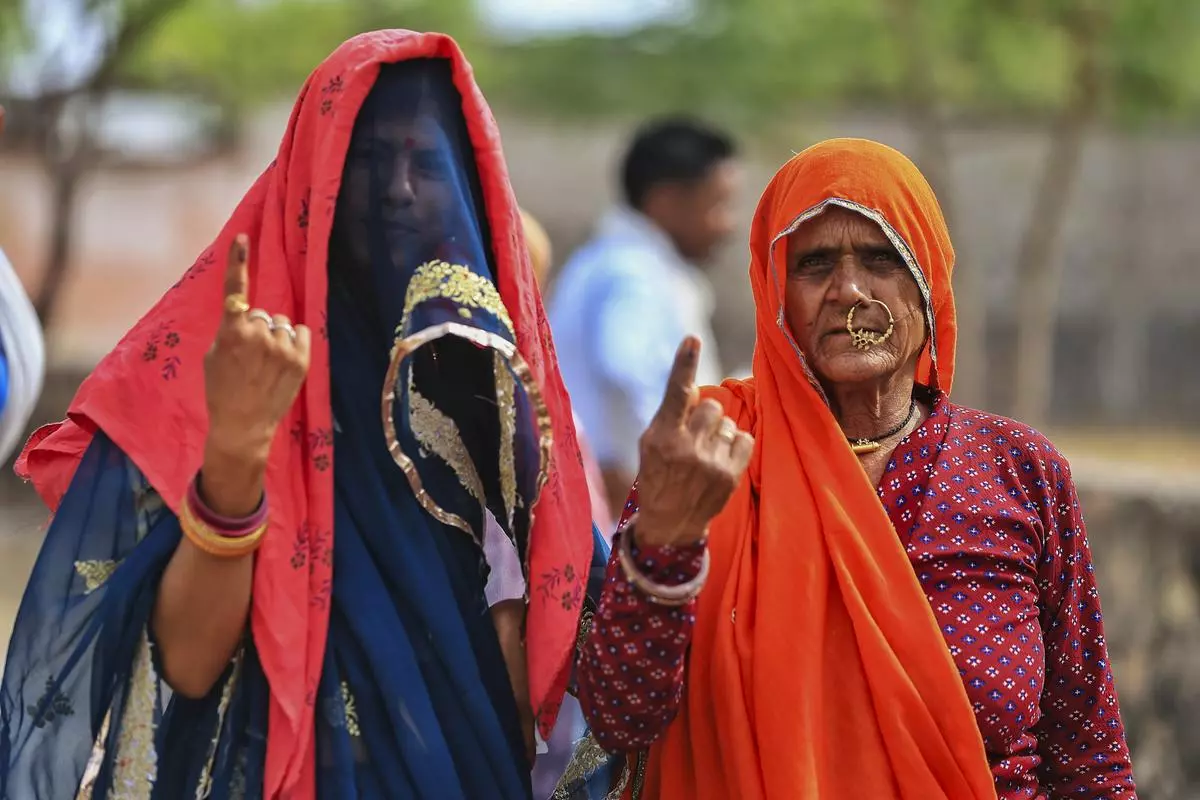 Women voters show their inked fingers after casting votes during the second phase of the Lok Sabha election, in Dudu district, Rajasthan, on April 26. Women voters show their inked fingers after casting votes during the second phase of the Lok Sabha election, in Dudu district, Rajasthan, on April 26.