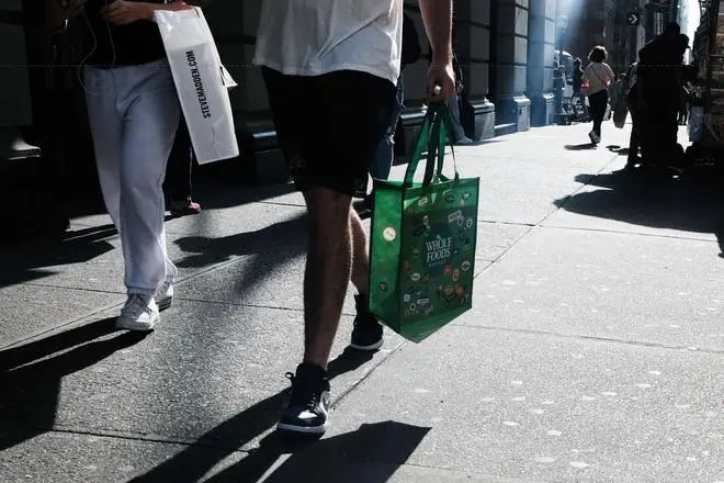 People walking down a shopping street in Manhattan in New York City on October 26. People walking down a shopping street in Manhattan in New York City on October 26.