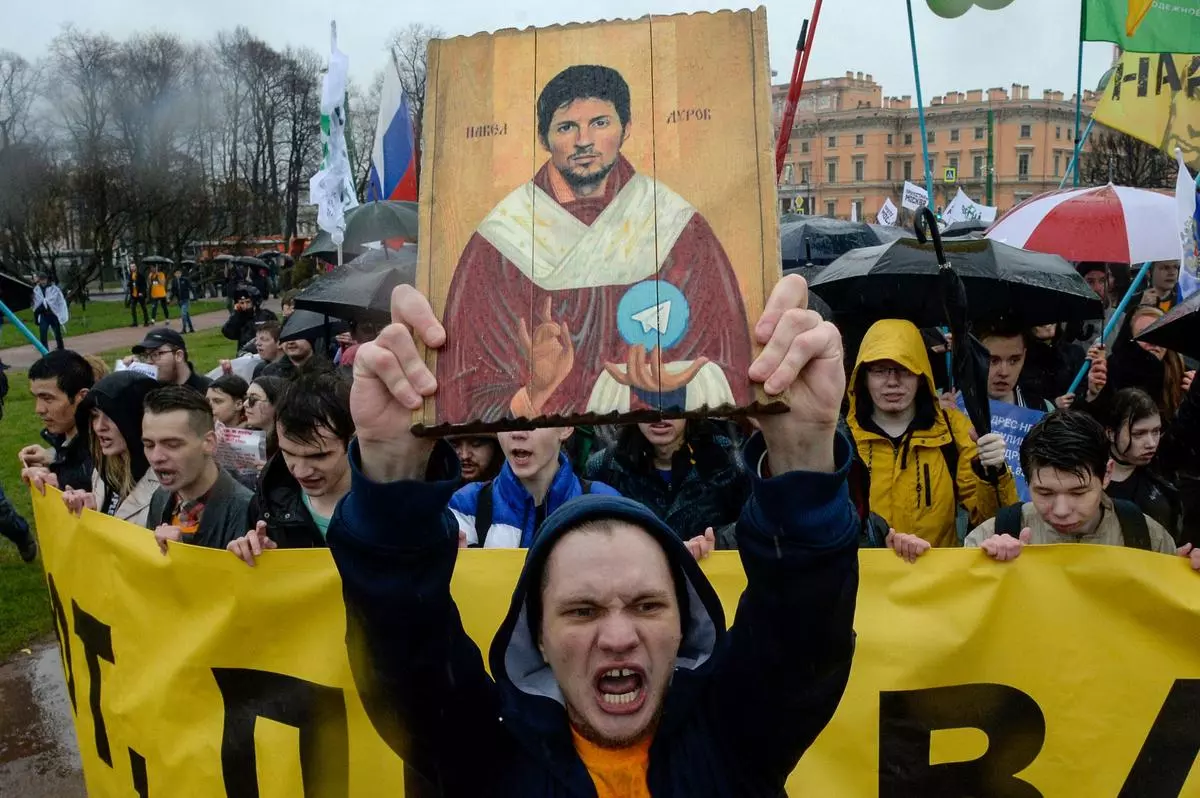 Demonstrators with a icon stylised painting depicting Telegram’s founder Pavel Durov protest against the blocking of the popular messaging app in Russia, during a May Day rally in St Petersburg on May 1, 2018.