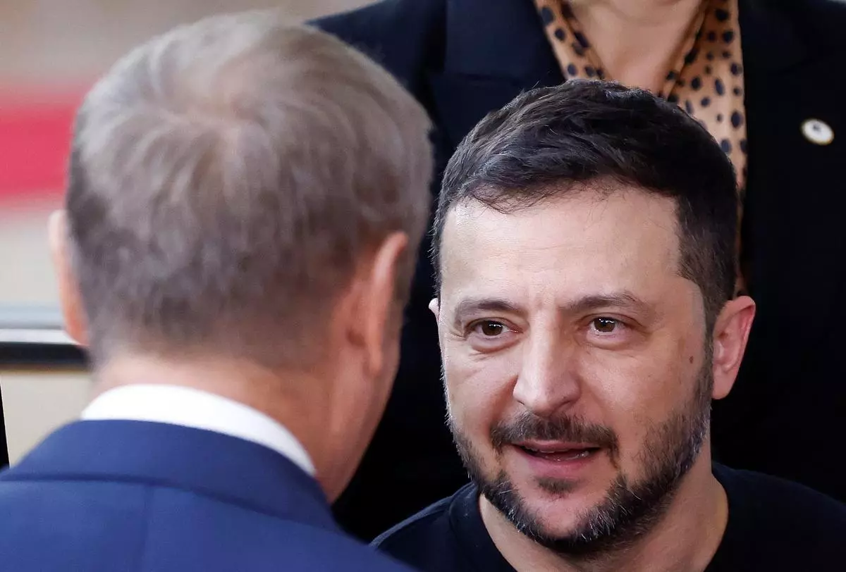 Ukraine’s President Volodymyr Zelenskiy speaks with Polish Prime Minister Donald Tusk as they attend a European Union leaders summit in Brussels, Belgium October 17, 2024. 