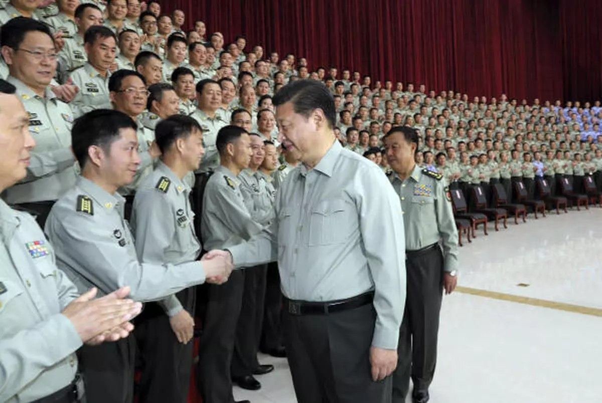 In this photo taken April 21, 2017, and released on April 22, 2017, by Xinhua News Agency, Chinese President Xi Jinping, who is also general secretary of the Communist Party of China (CPC) Central Committee and chairman of the Central Military Commission (CMC), meets with military officers during an inspection of the Southern Theater Command of the People’s Liberation Army (PLA).