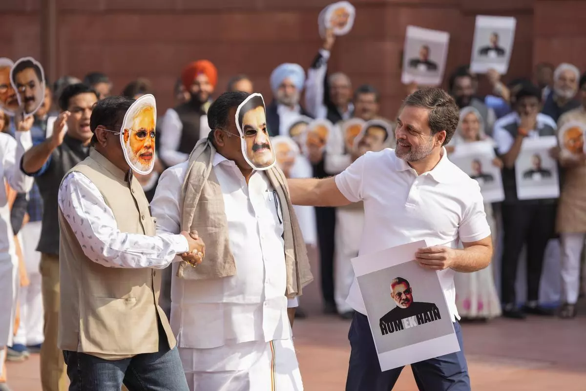 Congress leader Rahul Gandhi, right, with Congress MPs donning the masks of Narendra Modi and Gautam Adani, at a protest demanding a probe into the bribery case involving the billionaire industrialist. New Delhi, December 9, 2024. 