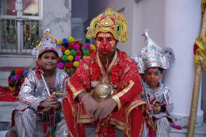 Two young Langurs with a Bajrangi at the Bada Hanuman temple. Two young Langurs with a Bajrangi at the Bada Hanuman temple.