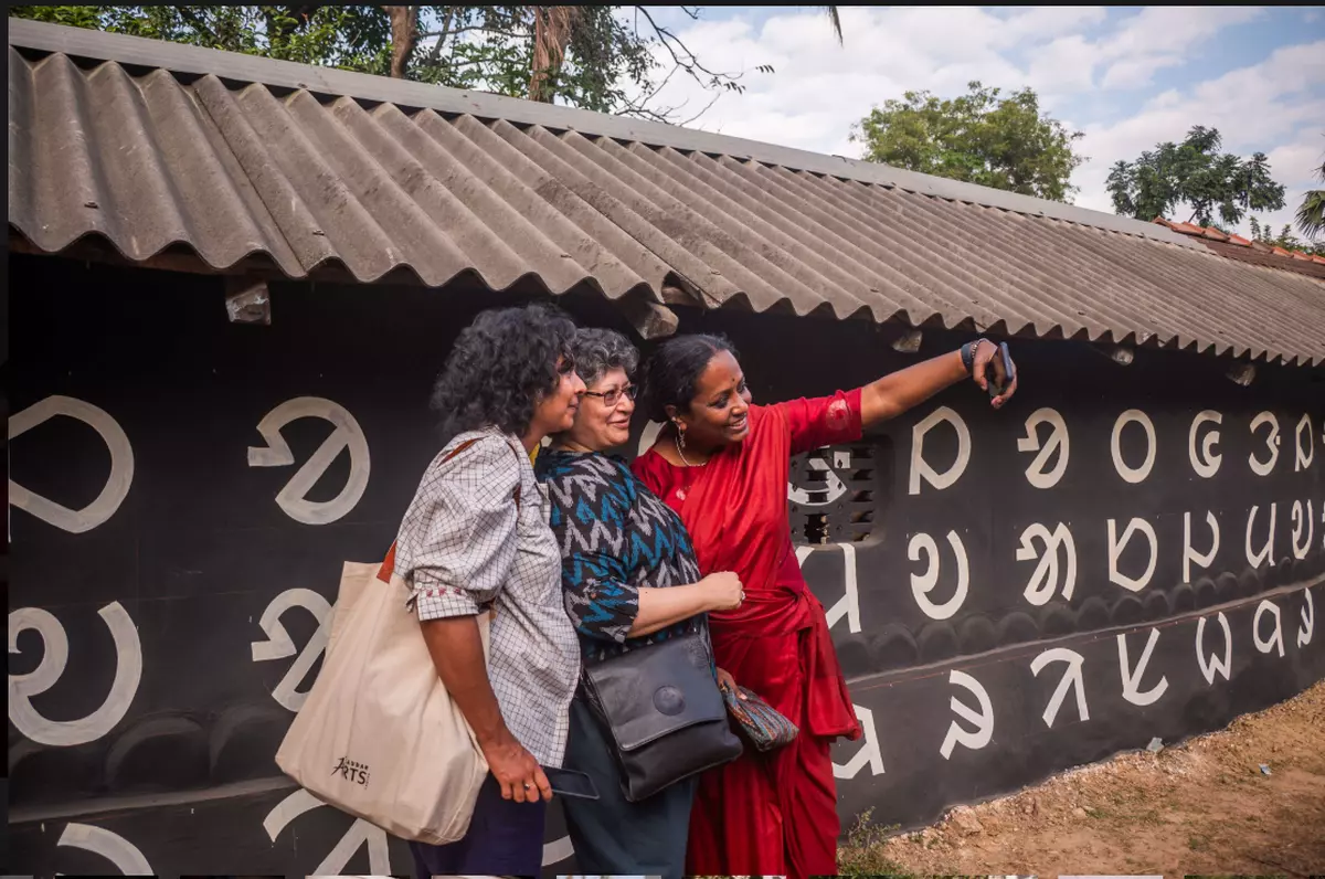 The installation “I am Ol Chiki” with Mithu Sen (in red sari).