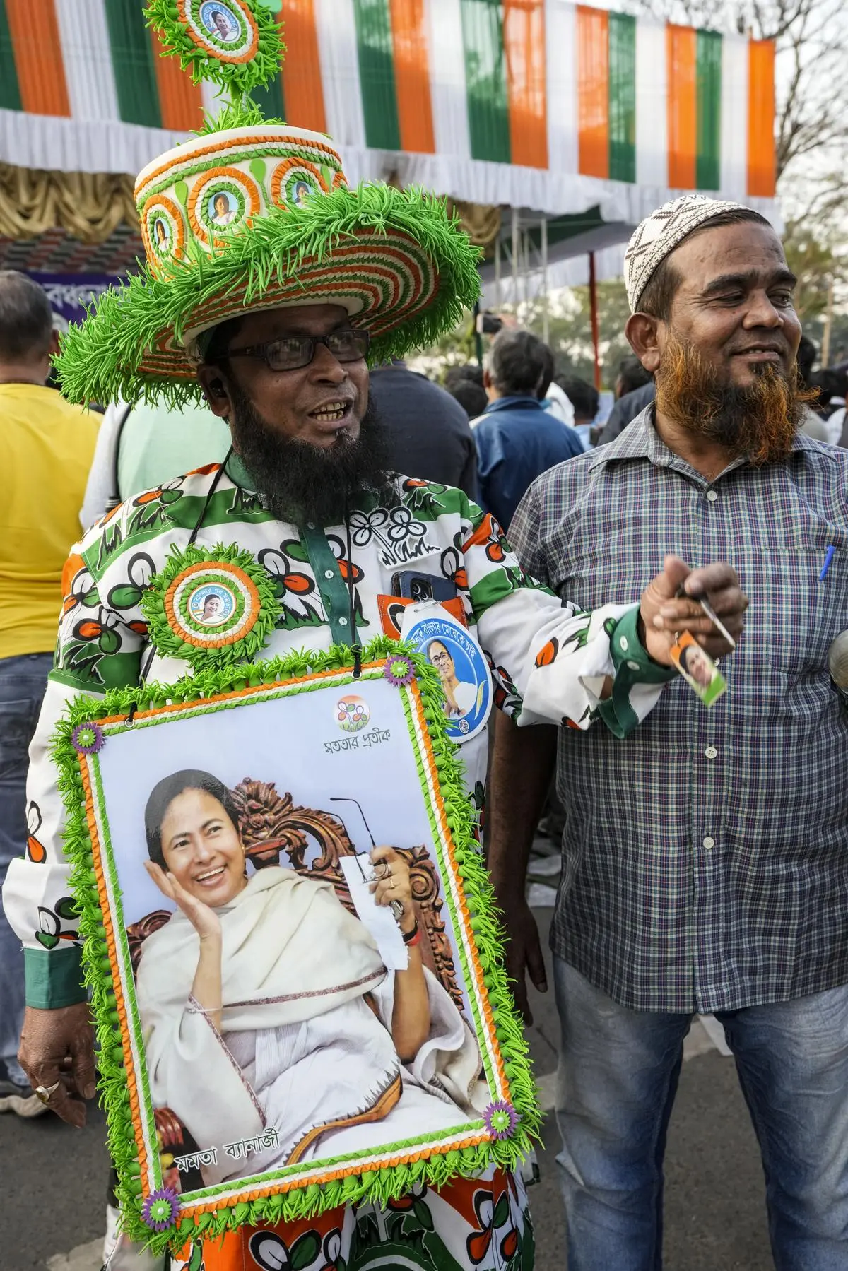 A TMC supporter wears a portrait of Mamata Banerjee during a sit-in protest in Kolkata, on February 3, demanding the release of Central funds for different welfare schemes.