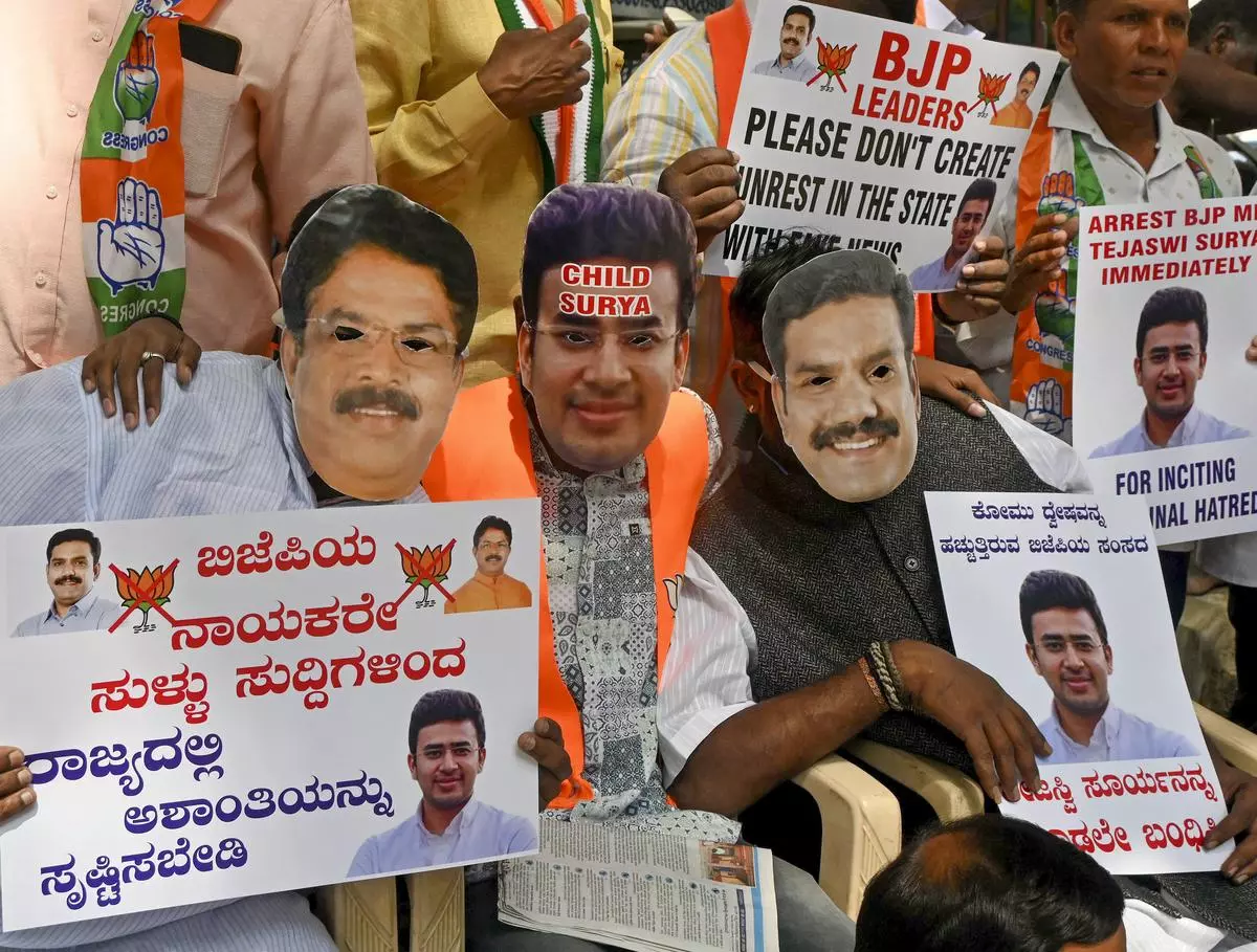 Congress workers at a protest against BJP MP Tejasvi Surya, who was booked for spreading fake news linking a farmer’s suicide to a land dispute with the Waqf Board, in Bengaluru on November 9. 