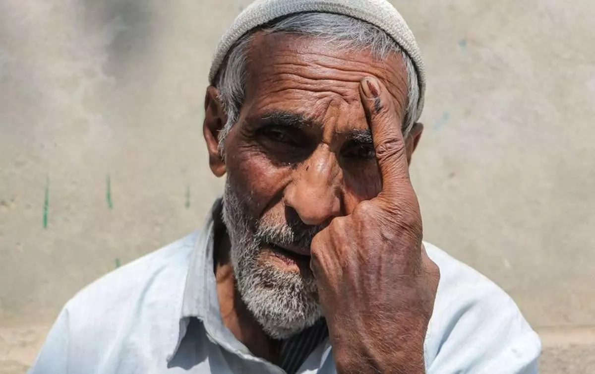 A man displays his inked finger after casting his vote at a polling station during the second phase of the Assembly elections in Budgam district on September 25, 2024.