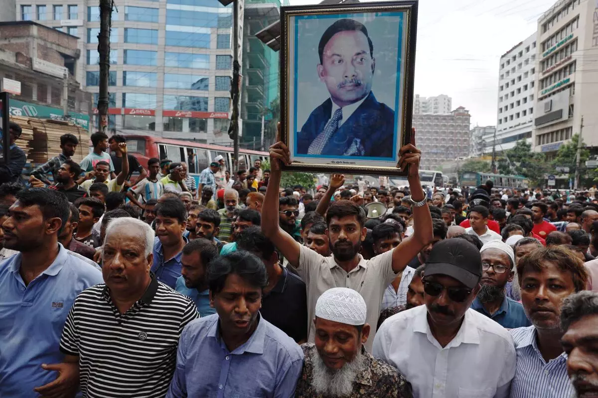 Supporter of Bangladesh Nationalist Party (BNP) holds a picture of former President Ziaur Rahman while joining in a rally, days after the resignation of former Prime Minister Sheikh Hasina, in Dhaka, Bangladesh, on August 7. 