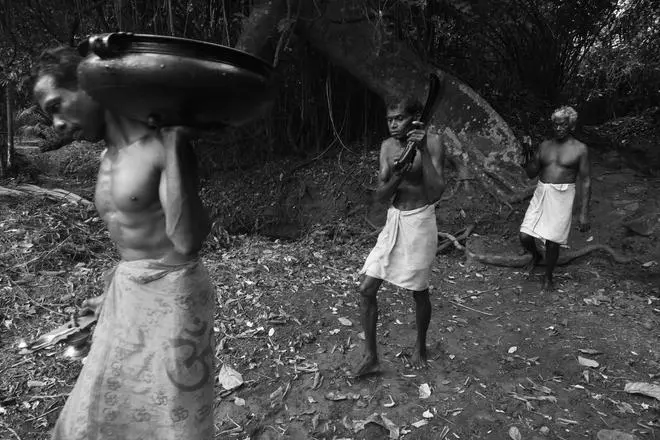 Mavilan community members perform a ritual before the start of Kankalan Theyyam. Mavilan community members perform a ritual before the start of Kankalan Theyyam.
