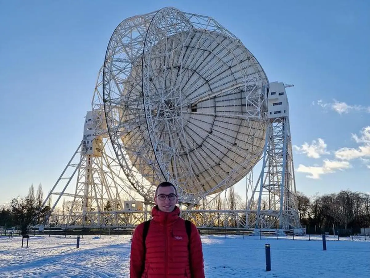 The Bielefeld University scientist  Lukas Böhme in front of the Lovell Telescope at the Jodrell Bank Radio Observatory in the UK.