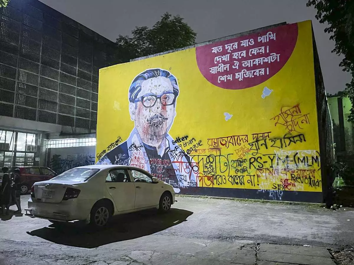 A mural celebrating the legacy of Bangladesh’s first President, Sheikh Mujibur Rahman, defaced with graffiti, in the Dhaka University campus.  