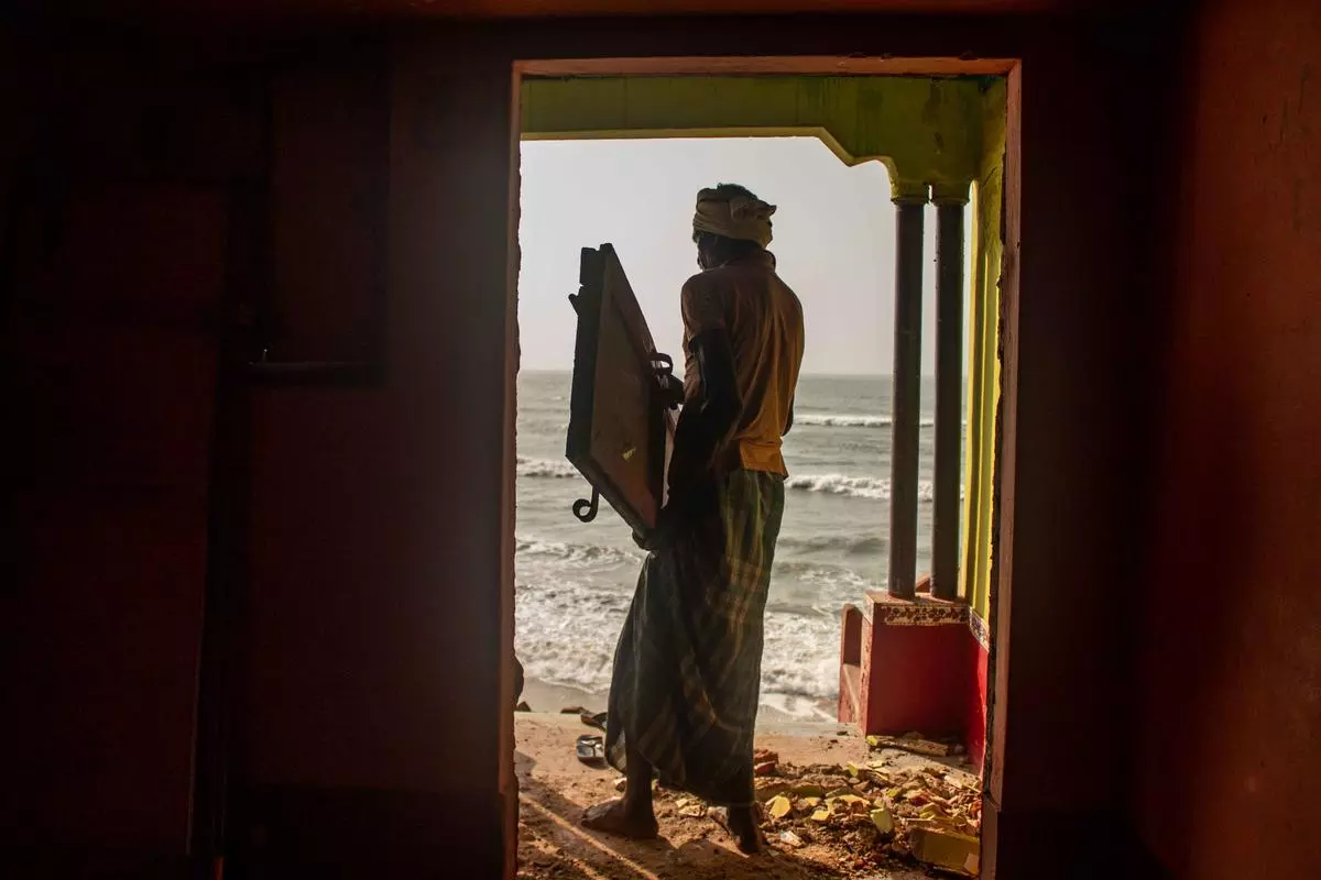 An elderly resident of Ganjam leaves his house behind as the sea water has finally reached his doorstep.