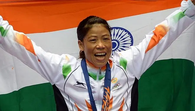 Mary Kom celebrating during the victory ceremony after winning the women’s flyweight (48-51kg) boxing final match against Kazakhstan’s Shekerbekova Zhaina during the 2014 Asian Games at the Seonhak Gymnasium in Incheon. Mary Kom celebrating during the victory ceremony after winning the women’s flyweight (48-51kg) boxing final match against Kazakhstan’s Shekerbekova Zhaina during the 2014 Asian Games at the Seonhak Gymnasium in Incheon.