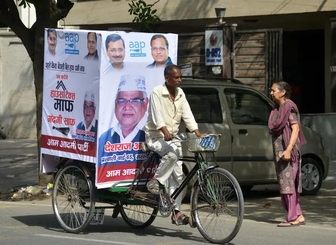 A rickshaw puller campaigns for the AAP in the Shakurbasti area of New Delhi in 2017. A rickshaw puller campaigns for the AAP in the Shakurbasti area of New Delhi in 2017.