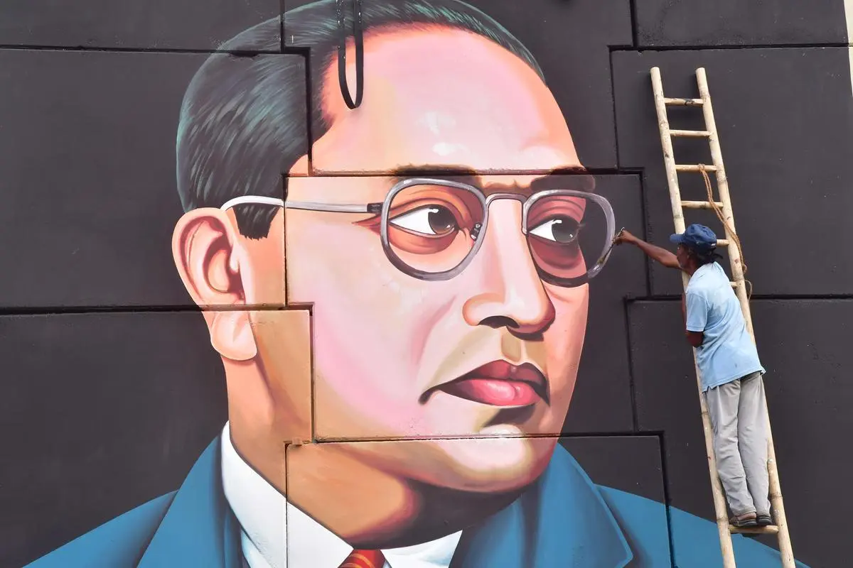 An artist painting a portrait of Dr. B.R. Ambedkar on a wall near Vijayawada, Andhra Pradesh, on August 26, 2022.