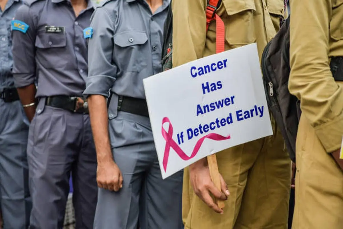 Participants hold placards reading “Cancer has an answer, if detected early” during a rally marking National Cancer Awareness Day, observed annually in India, on November 7, 2019, at Kolkata.