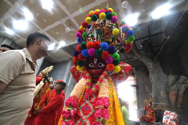 Narinder Kumar Suri, leader of one of the Bajrangi Sena groups that go around the smaller temples in the area and the Bada Hanuman temple during the mela. His mask, he says, is more than 400 years old and has been with his family for four generations. Narinder Kumar Suri, leader of one of the Bajrangi Sena groups that go around the smaller temples in the area and the Bada Hanuman temple during the mela. His mask, he says, is more than 400 years old and has been with his family for four generations.