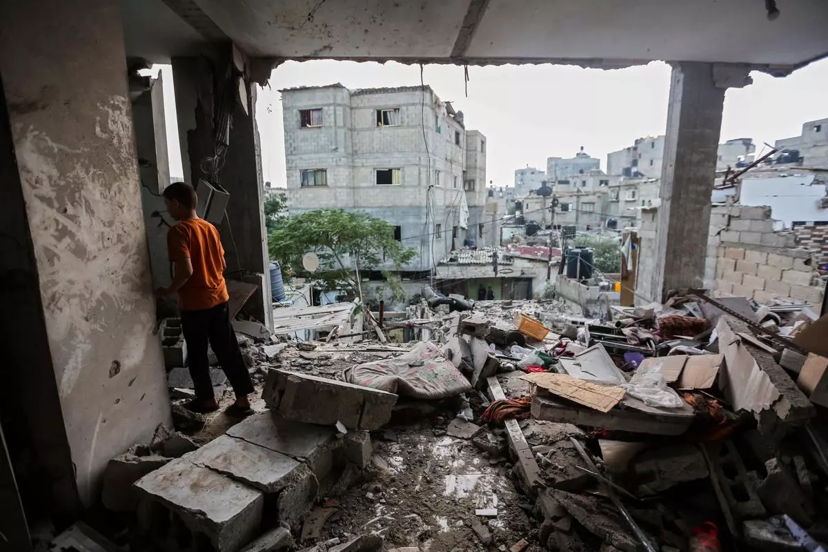 Searching through buildings that were destroyed during Israeli air raids in the southern Gaza Strip in Khan Yunis on October 25.