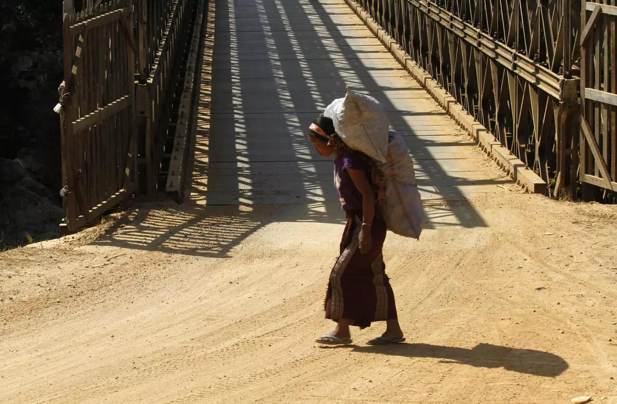 A labourer from Myanmar carries sacks filled with charcoal for sale in the Indian border town of Moreh in Manipur in February 2012. The India-Myanmar border is than a drab political boundary—it is a living thing that breathes life into an otherwise hostile and remote administrative frontier.