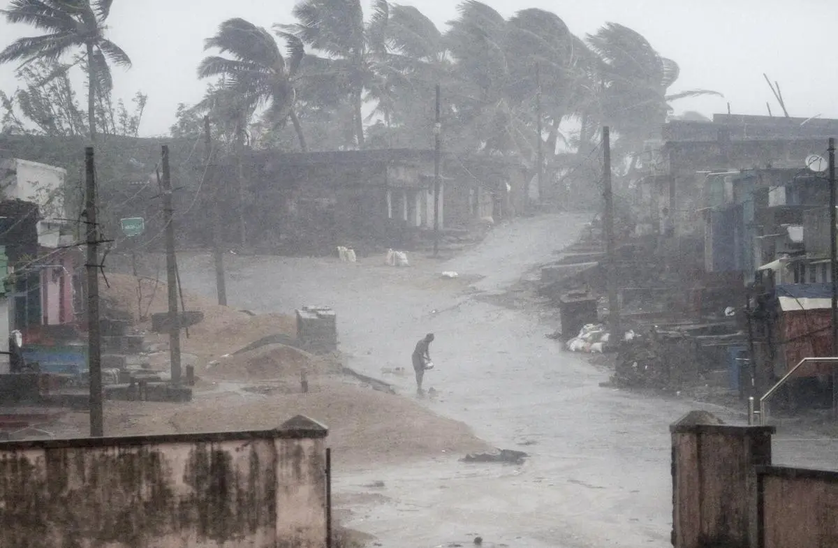 A man standing near Aryapalli beach during rain and strong winds caused by a cyclonic storm named Titli, or Butterfly, near Gopalpur on the Bay of Bengal coast, Ganjam district, in the eastern Indian state of Orissa, on October 11, 2018.