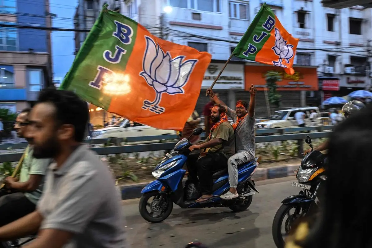 Supporters of the BJP celebrate after taking the lead during vote counting for the West Bengal Legislative Assembly elections, in Kolkata, on May 4, 2026.