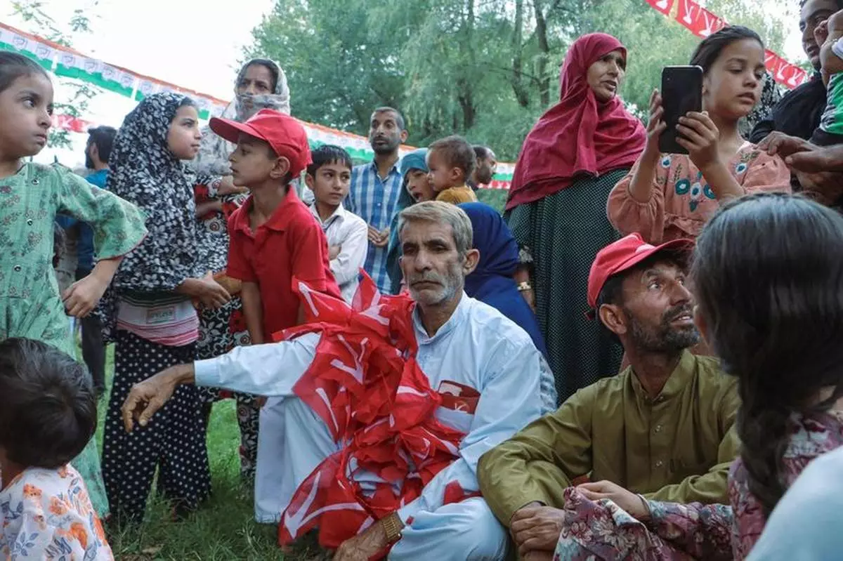 A supporter of the Jammu and Kashmir National Conference (JKNC) wore party flags while attending a rally in Tangmarg town, Baramulla district, on September 19, 2024.