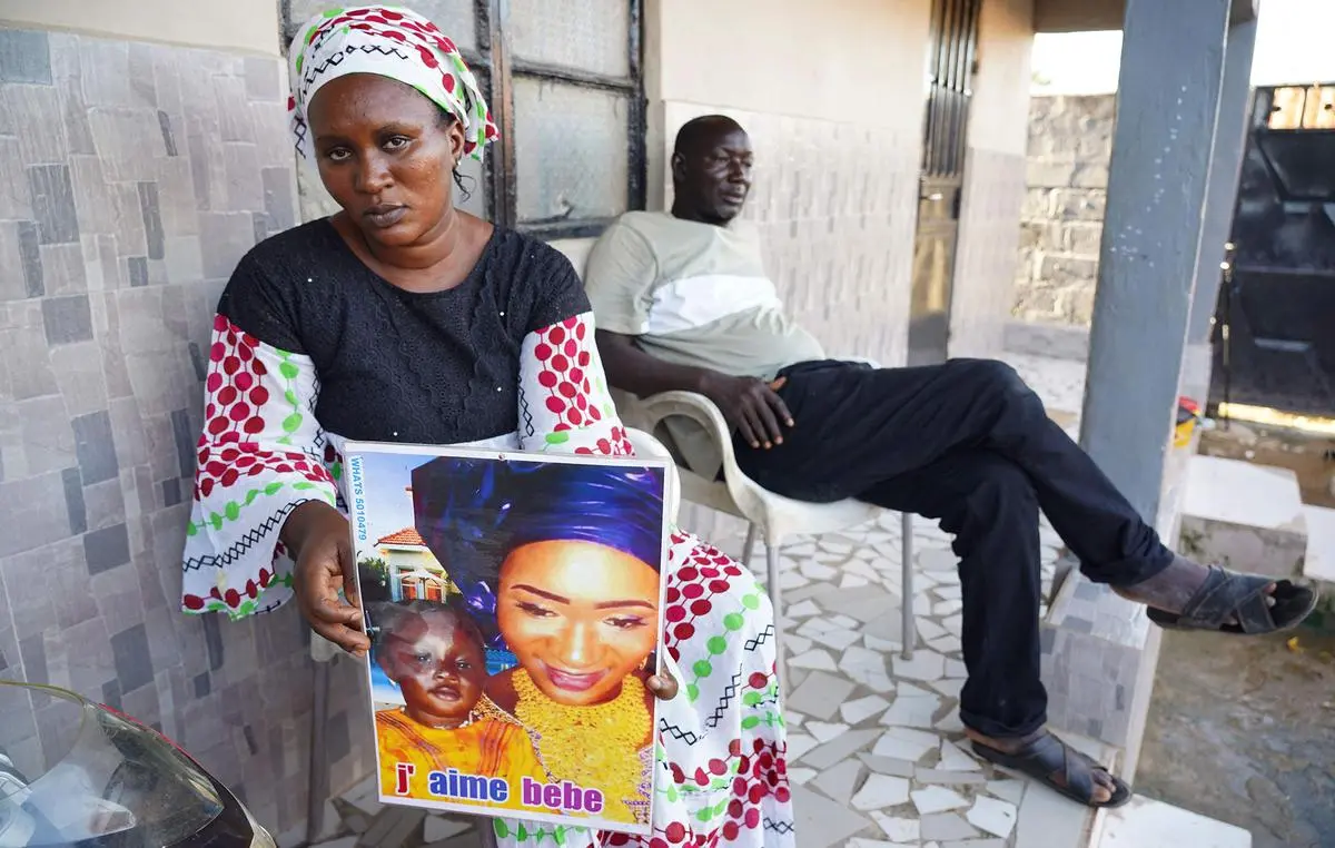 Mariama Kuyateh, 30, with a picture of her late son Musa, who died from acute kidney failure, in Banjul, The Gambia on October 10, 2022. The WHO said cough syrup produced by India-based Maiden Pharmaceuticals could be responsible for the deaths of 66 Gambian children, most under five years old.