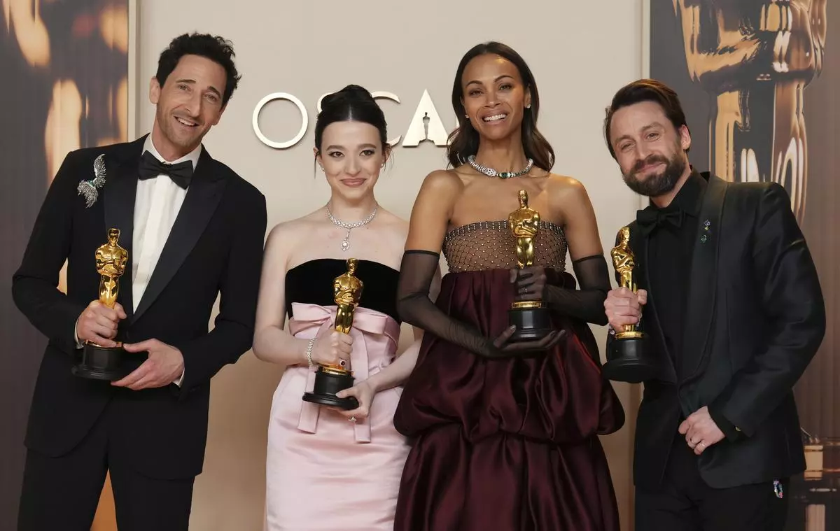 (L-R) Adrien Brody (Best Actor for The Brutalist), Mikey Madison (Best Actress for Anora), Zoe Saldana (Best Supporting Actress for Emilia Perez), and Kieran Culkin (Best Supporting Actor for A Real Pain), pose at the Oscars on March 2, 2025, at the Dolby Theatre in Los Angeles.