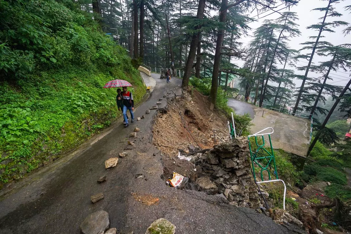 A road in Shimla is partially washed away after heavy rainfall. August 21, 2023. 