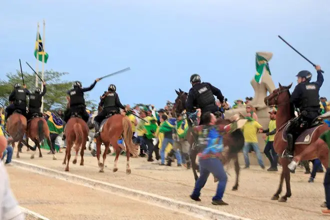 Mounted riot police fend off the mob outside the Presidential Palace, in Brasilia on January 8. Mounted riot police fend off the mob outside the Presidential Palace, in Brasilia on January 8.