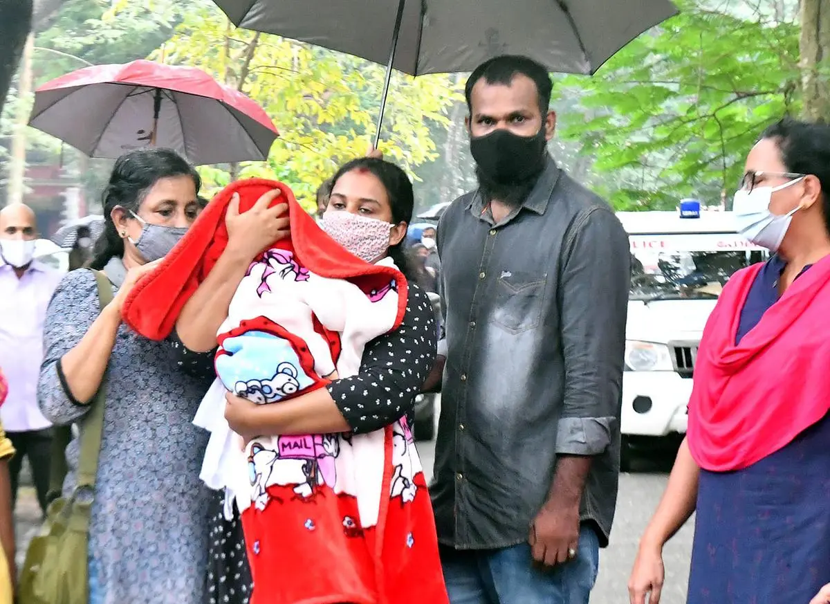 Anupama Chandran leaving a family court in Thiruvananthapuram in November 2021 with her child. Anupama won her son back after a long battle, after he was given up for adoption by her parents without her consent. 