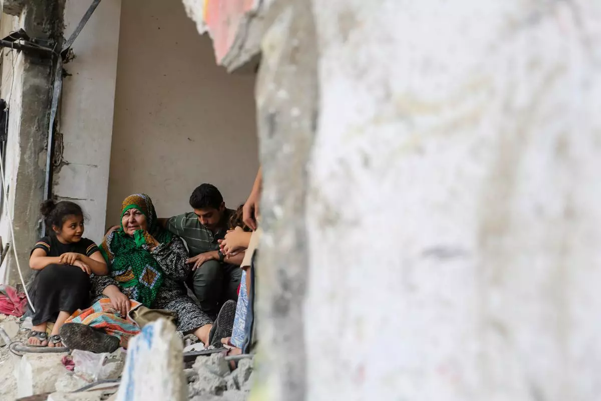 A family in one of the destroyed buildings in Khan Yunis, Gaza, on October 26.