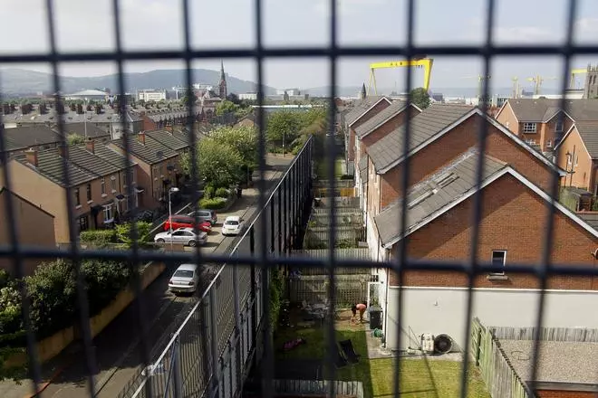 A massive wall and fence that separates a Protestant area from a Catholic one, in Belfast in 2013. 