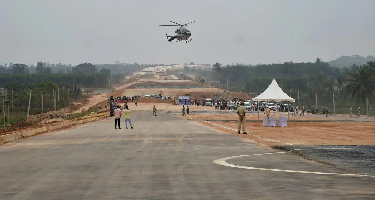 A helicopter about to land on the under-construction Bengaluru-Chennai Expressway near Bengaluru on January 5, 2023. Infrastructure projects such as expressways and flyovers have high political, rather than economic, value. They generate a sense of action even though their developmental value is suspect. 