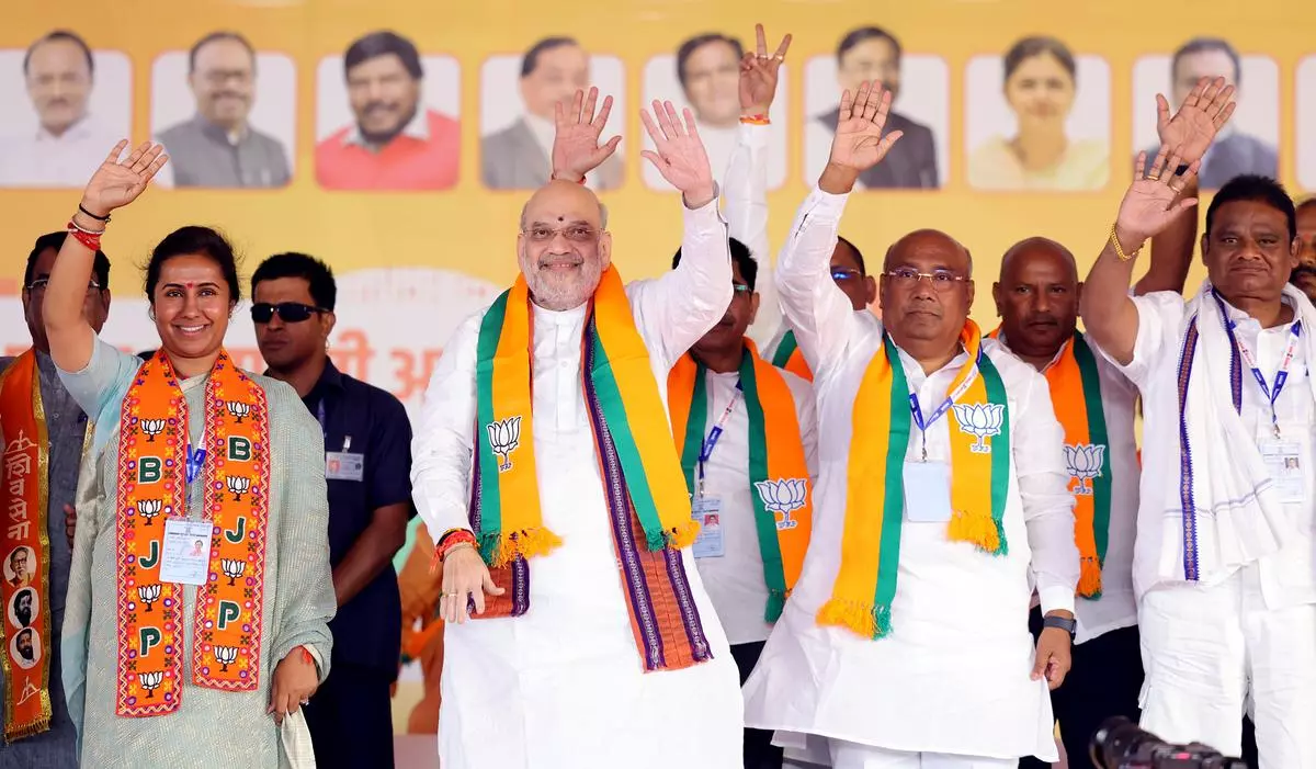 Union Home Minister Amit Shah waves to an audience during a public meeting in support of BJP candidate from Jintur, Meghana Bordikar. Parbhani, Maharashtra, November 13.