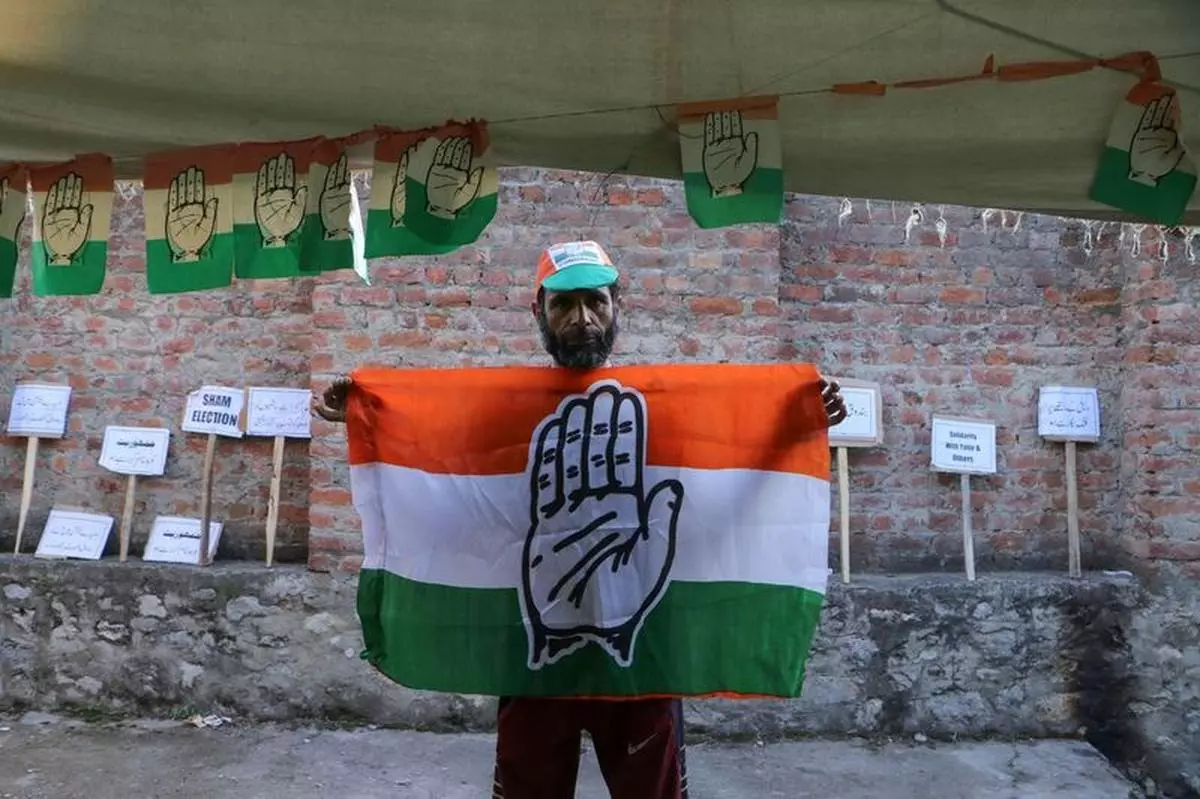 A Congress supporter with a party flag after the arrest of party members in Bandipora district, northern Kashmir Valley, September 29, 2024.