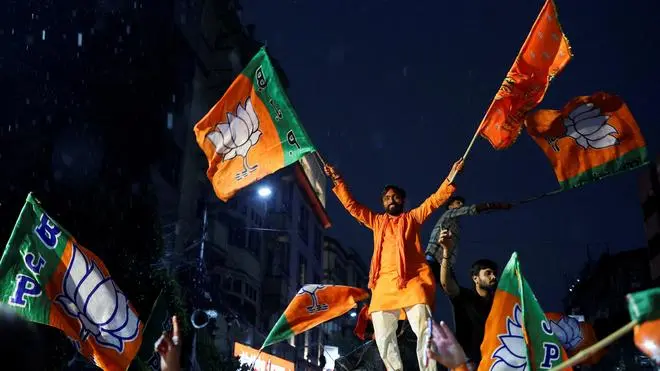 BJP supporters celebrate their party’s lead in the West Bengal Assembly election outside the party’s regional office in Kolkata on May 4, 2026.