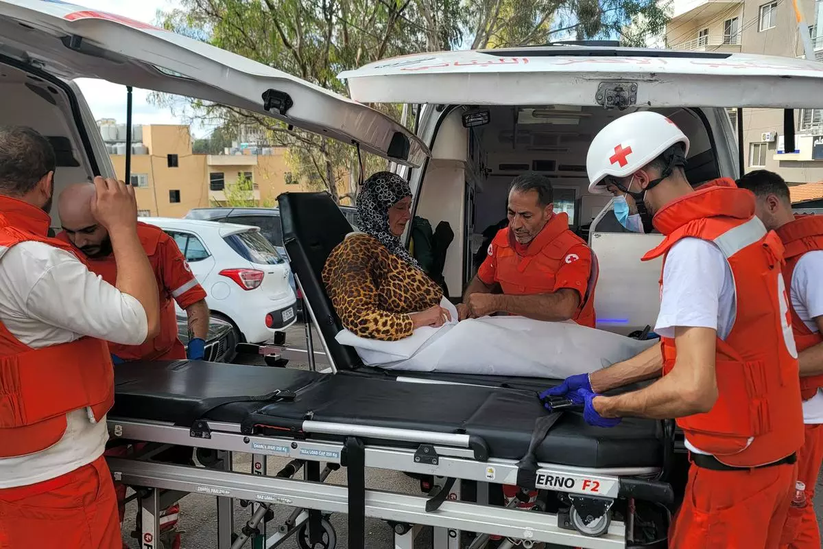 Volunteers with the Lebanese Red Cross evacuate a woman in the southern Lebanese city of Nabatieh on October 17, 2024.