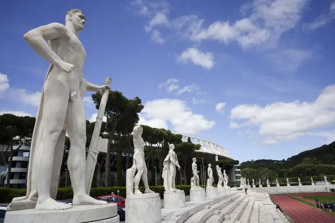 A marble statue holding a fasces—a bundle of rods tied together around an axe—adopted by Italian dictator Benito Mussolini as a symbol of power, adorns the Stadio dei Marmi (‘Stadium of the Marbles’) in the sports complex, the Foro Italico, in Rome. A marble statue holding a fasces—a bundle of rods tied together around an axe—adopted by Italian dictator Benito Mussolini as a symbol of power, adorns the Stadio dei Marmi (‘Stadium of the Marbles’) in the sports complex, the Foro Italico, in Rome.
