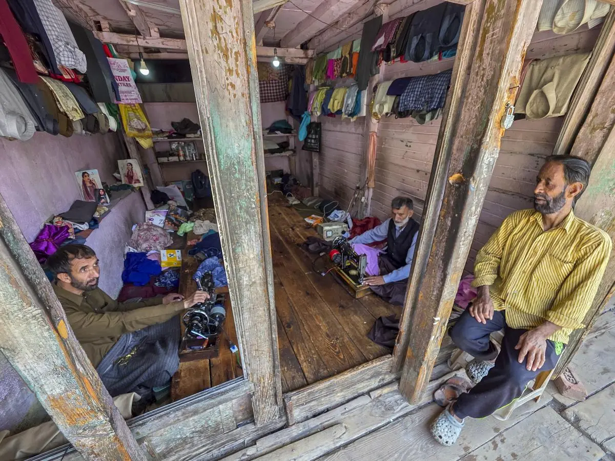 Tailors resuming work a day after India and Pakistan reached a bilateral consensus, at Uri in Baramulla district, on May 11. Tailors resuming work a day after India and Pakistan reached a bilateral consensus, at Uri in Baramulla district, on May 11.