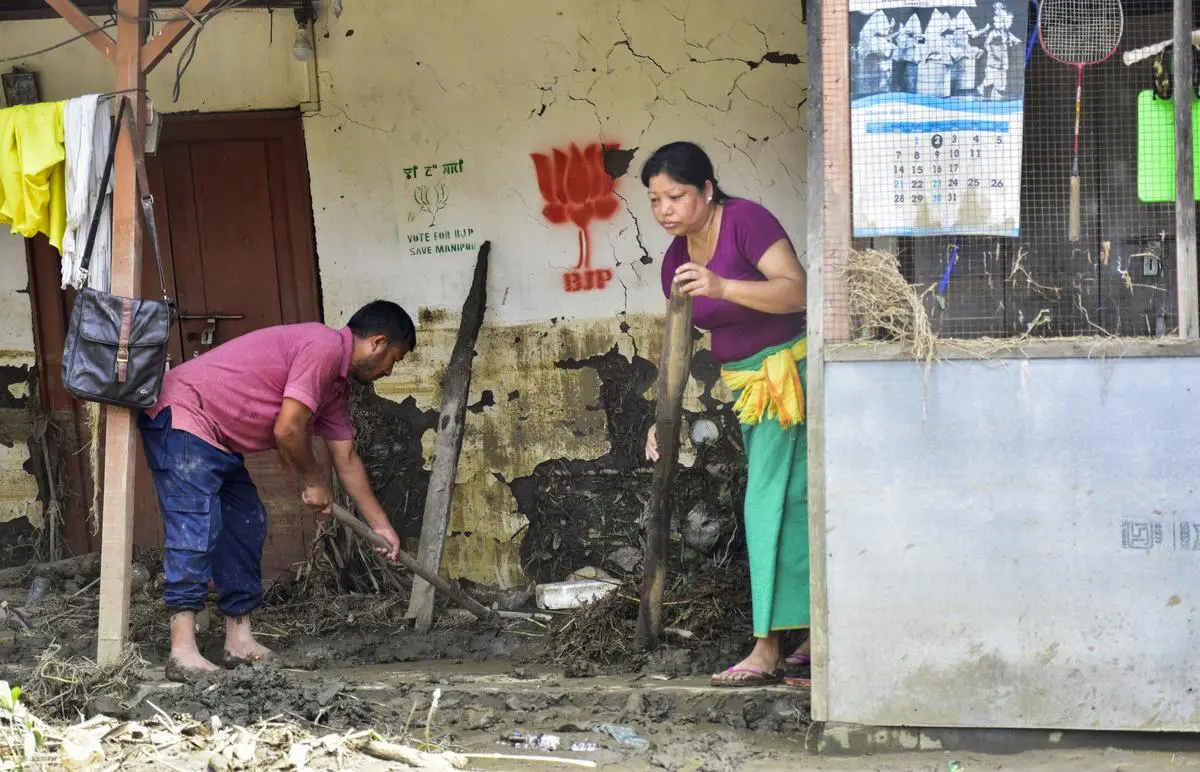 Residents clear the debris left behind by the floods in Imphal East district, Manipur, on June 4. Residents clear the debris left behind by the floods in Imphal East district, Manipur, on June 4.